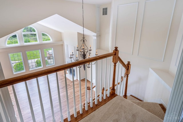 7194 Orchard View Ln, Salem Twp, OH 45152 - staircase with lofted ceiling, wood finished floors, and a chandelier