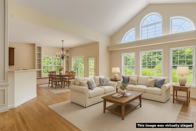 7194 Orchard View Ln, Salem Twp, OH 45152 - living area with a chandelier, light wood-type flooring, and high vaulted ceiling