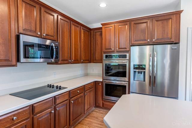 7194 Orchard View Ln, Salem Twp, OH 45152 - kitchen featuring appliances with stainless steel finishes, light countertops, recessed lighting, and light wood-style floors