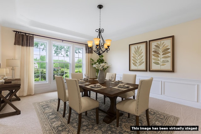 7194 Orchard View Ln, Salem Twp, OH 45152 - dining room with light carpet, a chandelier, wainscoting, and a decorative wall