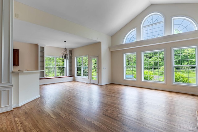7194 Orchard View Ln, Salem Twp, OH 45152 - unfurnished living room with a chandelier, wood finished floors, and high vaulted ceiling