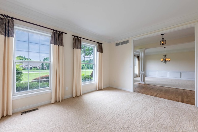 7194 Orchard View Ln, Salem Twp, OH 45152 - spare room featuring a chandelier, carpet flooring, crown molding, and ornate columns