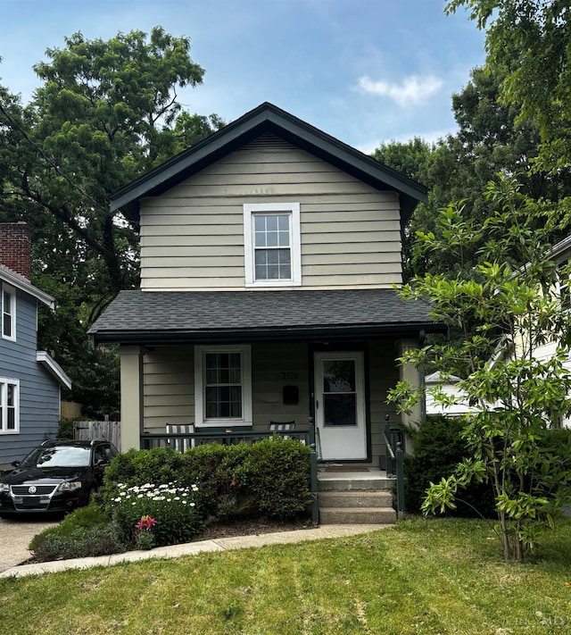 3126 Mapleleaf Ave, Cincinnati, OH 45213 - view of front facade featuring covered porch, a shingled roof, and a front lawn