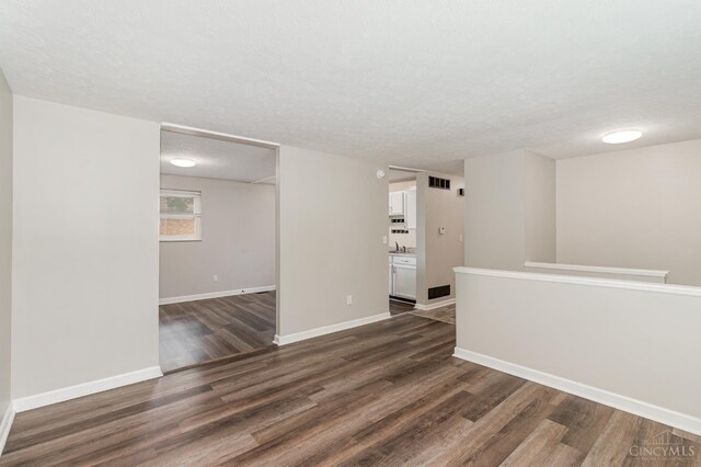 9733 Gertrude Ln, Springfield Twp, OH 45231 - empty room featuring dark wood finished floors and a textured ceiling