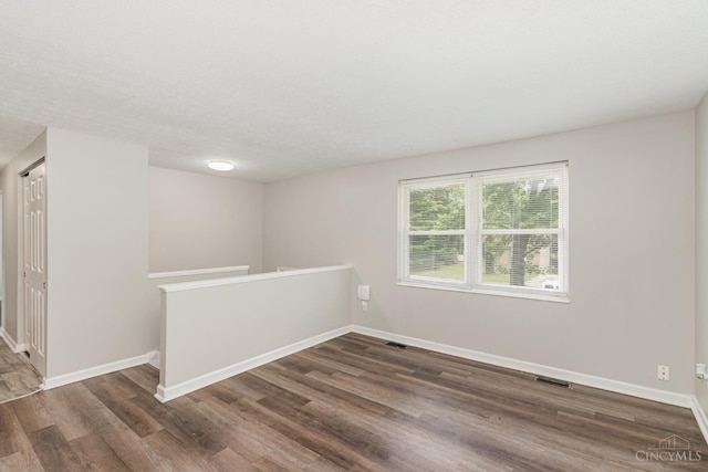 9733 Gertrude Ln, Springfield Twp, OH 45231 - empty room featuring dark wood-type flooring and baseboards