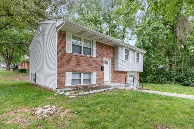 9733 Gertrude Ln, Springfield Twp, OH 45231 - bi-level home with a front yard, an attached garage, and brick siding