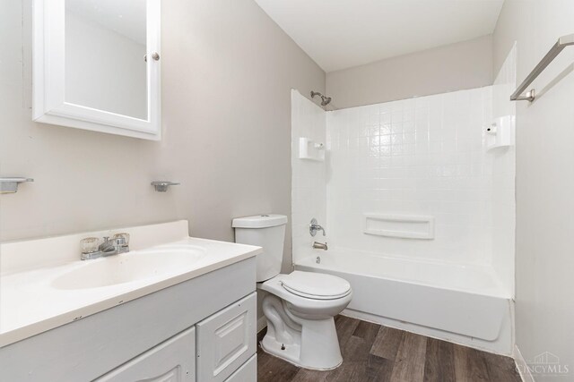 9733 Gertrude Ln, Springfield Twp, OH 45231 - full bathroom featuring wood finished floors, vanity, and shower / bath combination