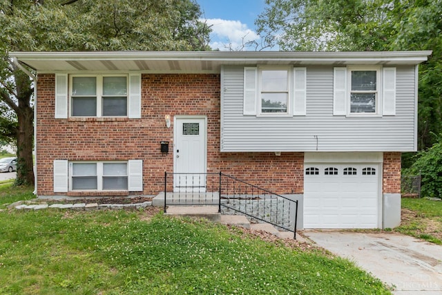 9733 Gertrude Ln, Springfield Twp, OH 45231 - split foyer home with concrete driveway, a garage, brick siding, and a front lawn