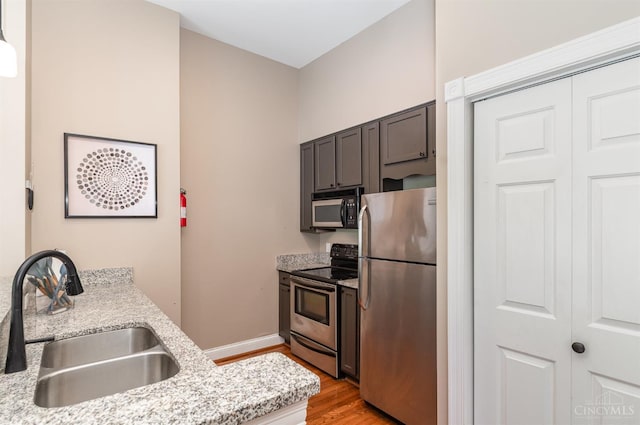 2110 Fulton Ave Unit D1, Cincinnati, OH 45206 - kitchen with stainless steel appliances, light wood-style flooring, and light stone counters