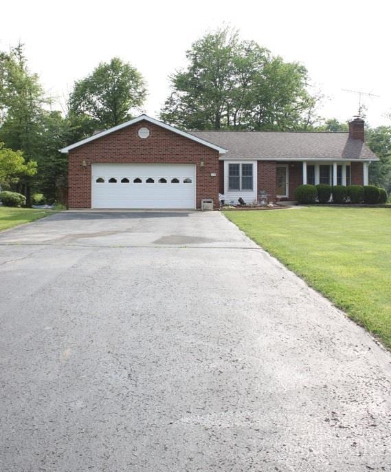 10 Chippewa Cv, Sardinia, OH 45171 - ranch-style house with a chimney, driveway, brick siding, and a front yard