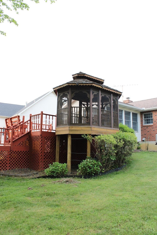 10 Chippewa Cv, Sardinia, OH 45171 - rear view of house with a sunroom, a deck, and a yard