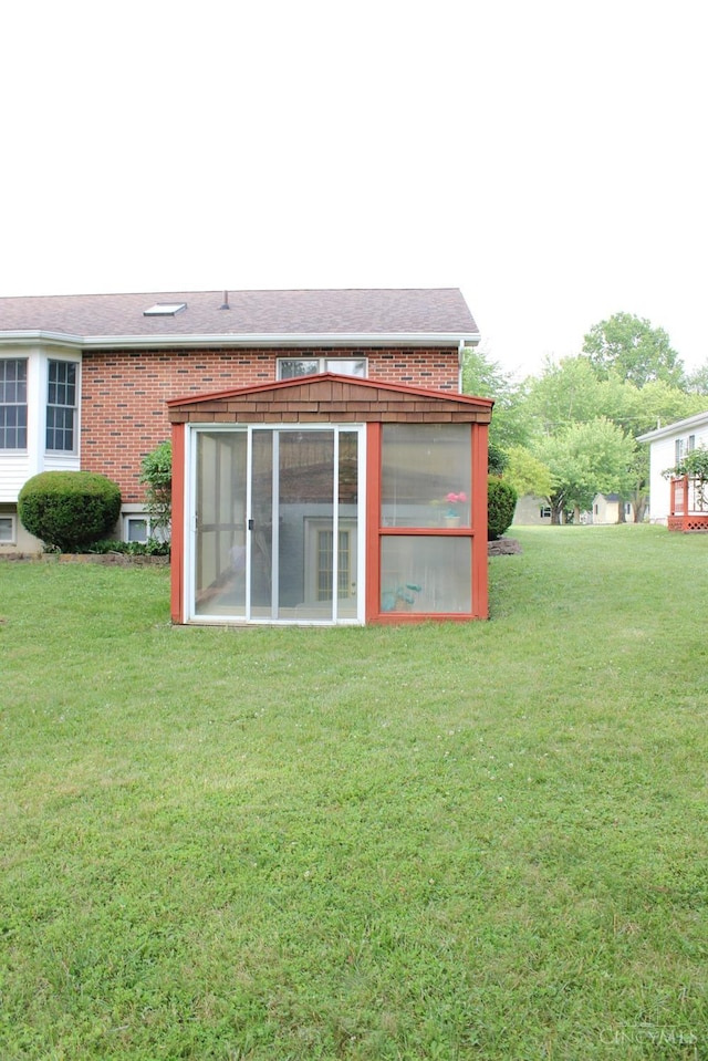 10 Chippewa Cv, Sardinia, OH 45171 - back of house featuring a sunroom, brick siding, and a lawn