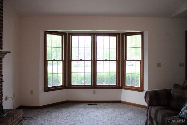 10 Chippewa Cv, Sardinia, OH 45171 - unfurnished living room featuring carpet floors, plenty of natural light, and a brick fireplace