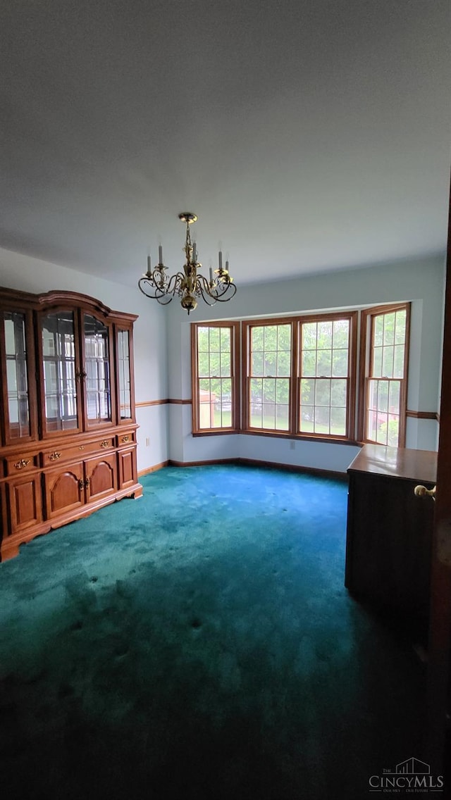 10 Chippewa Cv, Sardinia, OH 45171 - unfurnished living room featuring a chandelier and carpet flooring