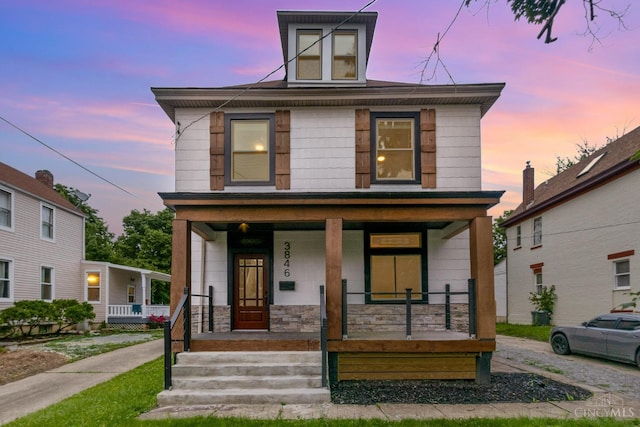3846 Davis Ave, Cheviot, OH 45211 - american foursquare style home featuring a porch and stone siding