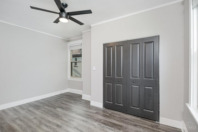 3846 Davis Ave, Cheviot, OH 45211 - unfurnished bedroom with crown molding, wood finished floors, a closet, and ceiling fan