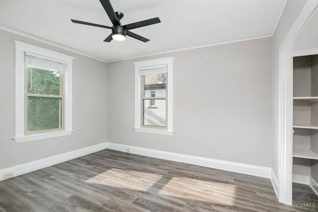 3846 Davis Ave, Cheviot, OH 45211 - unfurnished room featuring dark wood-type flooring, ceiling fan, crown molding, and plenty of natural light