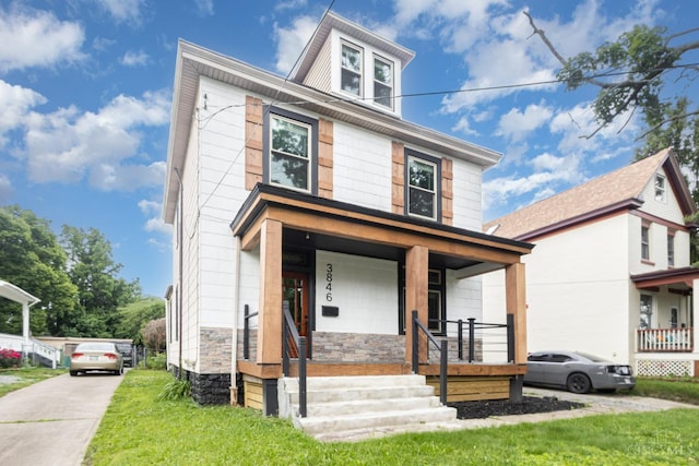 3846 Davis Ave, Cheviot, OH 45211 - american foursquare style home featuring a porch, stone siding, and a front lawn