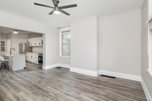 3846 Davis Ave, Cheviot, OH 45211 - unfurnished living room with a ceiling fan and wood finished floors