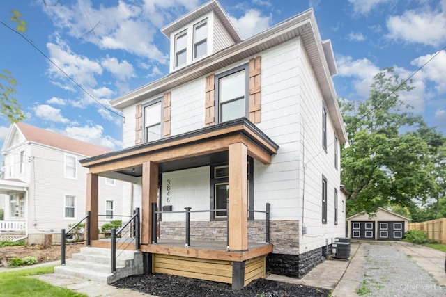 3846 Davis Ave, Cheviot, OH 45211 - american foursquare style home featuring a porch, a garage, stone siding, and an outbuilding