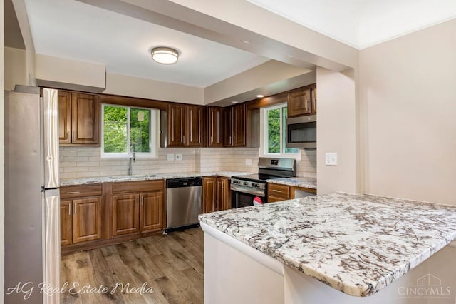 1502 Shenandoah, Cincinnati, OH 45237 - kitchen featuring stainless steel appliances, light wood-type flooring, tasteful backsplash, and light stone countertops