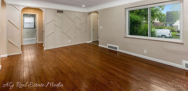 1502 Shenandoah, Cincinnati, OH 45237 - unfurnished bedroom featuring arched walkways, wood-type flooring, multiple windows, and recessed lighting