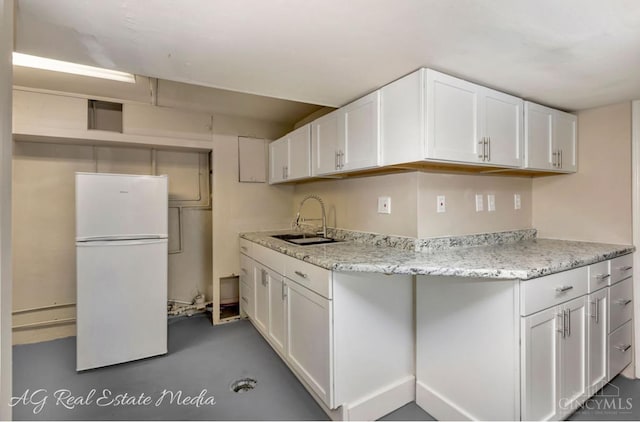 1502 Shenandoah, Cincinnati, OH 45237 - kitchen featuring freestanding refrigerator, white cabinets, finished concrete flooring, and light stone counters