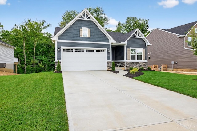 1285 Millstream Dr, Batavia Twp, OH 45102 - craftsman house featuring a front yard, concrete driveway, stone siding, and an attached garage