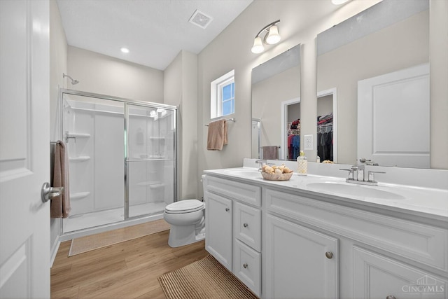 1285 Millstream Dr, Batavia Twp, OH 45102 - bathroom featuring double vanity, a stall shower, wood finished floors, and a spacious closet