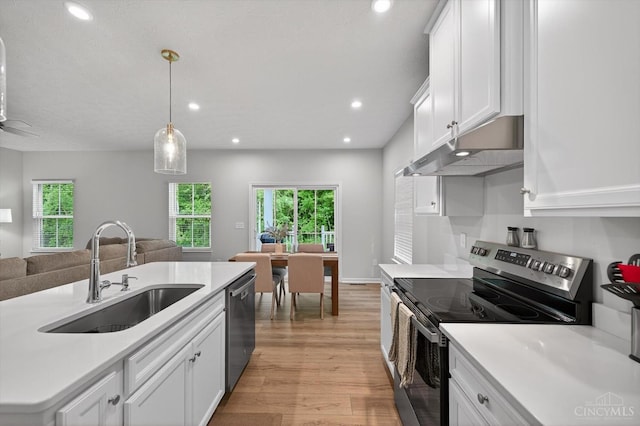 1285 Millstream Dr, Batavia Twp, OH 45102 - kitchen featuring appliances with stainless steel finishes, under cabinet range hood, open floor plan, light wood-style flooring, and light countertops