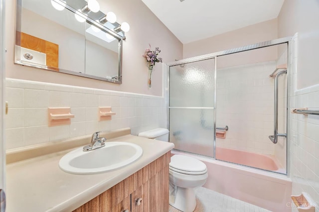 5505 Goldcrest Dr, Green Twp, OH 45238 - full bath with shower / bath combination with glass door, tile walls, vanity, and wainscoting
