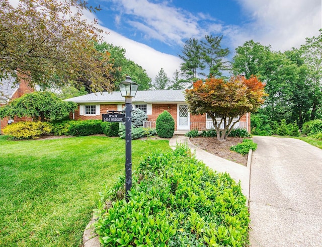 5505 Goldcrest Dr, Green Twp, OH 45238 - view of front of home with a front yard, brick siding, and driveway