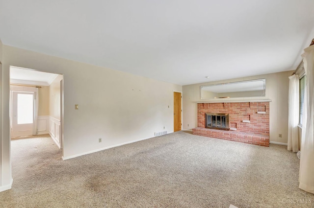5505 Goldcrest Dr, Green Twp, OH 45238 - unfurnished living room with carpet flooring, a fireplace, a wainscoted wall, and a decorative wall