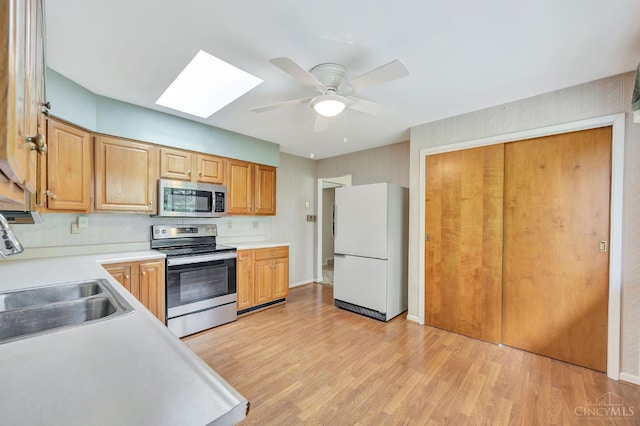 5505 Goldcrest Dr, Green Twp, OH 45238 - kitchen featuring appliances with stainless steel finishes, a skylight, light countertops, and a ceiling fan