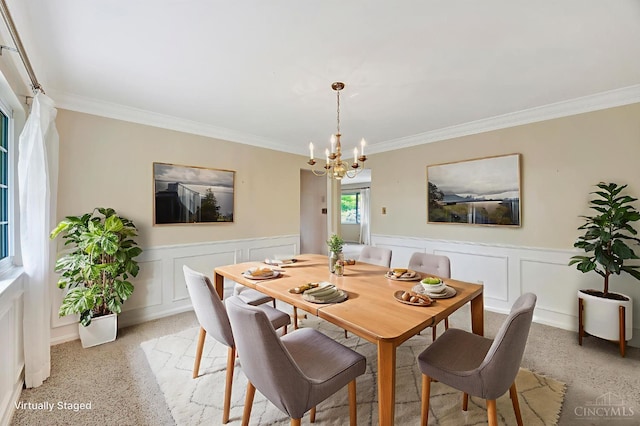 5505 Goldcrest Dr, Green Twp, OH 45238 - dining area featuring a decorative wall, a chandelier, ornamental molding, a wainscoted wall, and dark aggregate flooring