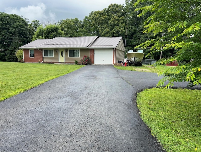 5855 Ivy Hill Rd, Hillsboro, OH 45133 - ranch-style home with an attached garage, a front lawn, driveway, a metal roof, and brick siding