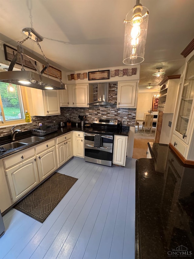 3969 S Fordham Pl, Silverton, OH 45213 - kitchen with double oven range, wall chimney range hood, dark countertops, and decorative backsplash