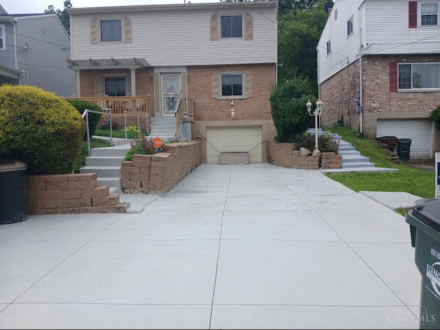 3969 S Fordham Pl, Silverton, OH 45213 - view of front of property with an attached garage, brick siding, driveway, and stairway
