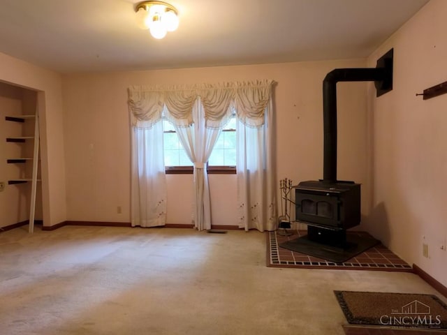 1601 W Concord Rd, Pierce Twp, OH 45102 - unfurnished living room featuring carpet floors and a wood stove