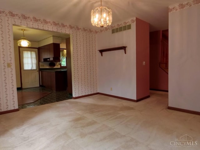 1601 W Concord Rd, Pierce Twp, OH 45102 - unfurnished living room featuring wallpapered walls, a chandelier, and carpet