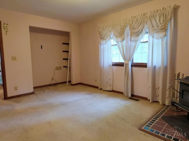 1601 W Concord Rd, Pierce Twp, OH 45102 - carpeted living room with a wood stove and baseboards