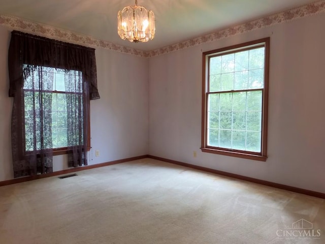 1601 W Concord Rd, Pierce Twp, OH 45102 - unfurnished room with a chandelier, carpet flooring, and healthy amount of natural light