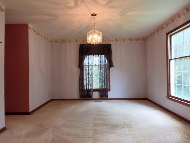 1601 W Concord Rd, Pierce Twp, OH 45102 - spare room with a chandelier, healthy amount of natural light, and light colored carpet