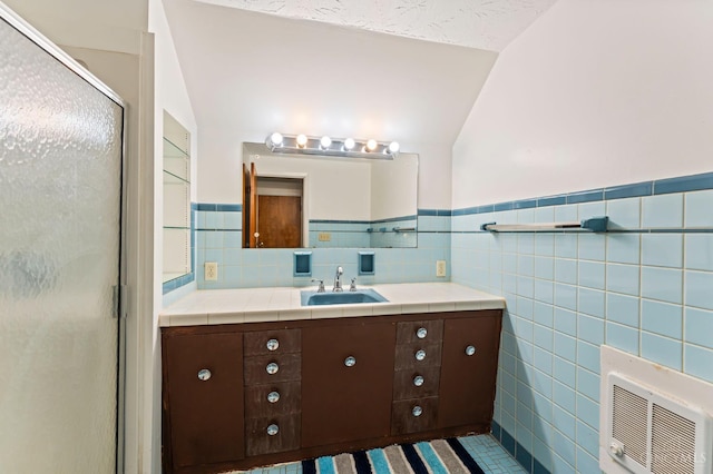 405 Hyde Park Dr, Hamilton, OH 45013 - full bath featuring tile walls, vanity, a stall shower, a wainscoted wall, and vaulted ceiling