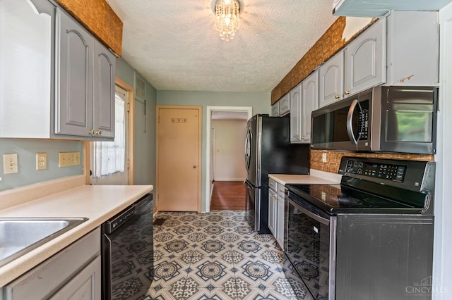 405 Hyde Park Dr, Hamilton, OH 45013 - kitchen with stainless steel microwave, range with electric stovetop, dishwasher, light countertops, and a textured ceiling