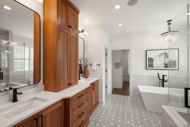 9317 E Kemper Rd, Symmes Twp, OH 45140 - full bath featuring a freestanding tub, ornamental molding, double vanity, a shower stall, and recessed lighting