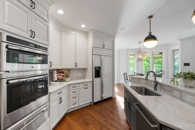 9317 E Kemper Rd, Symmes Twp, OH 45140 - kitchen with appliances with stainless steel finishes, a warming drawer, white cabinetry, recessed lighting, and ornamental molding