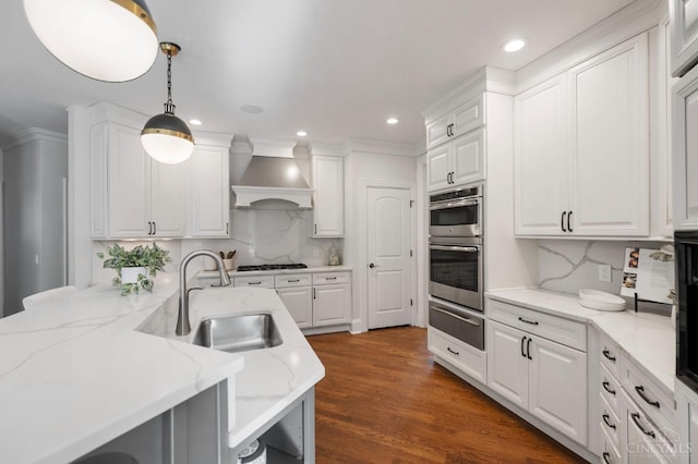 9317 E Kemper Rd, Symmes Twp, OH 45140 - kitchen with custom range hood, a warming drawer, white cabinets, gas stovetop, and hanging light fixtures