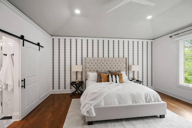 9317 E Kemper Rd, Symmes Twp, OH 45140 - bedroom featuring vaulted ceiling, a barn door, wood finished floors, multiple windows, and recessed lighting