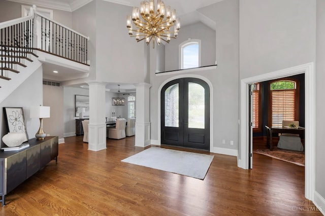 9317 E Kemper Rd, Symmes Twp, OH 45140 - entryway with a chandelier, french doors, plenty of natural light, a towering ceiling, and wood finished floors